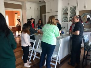 Group in kitchen cooking.